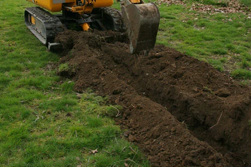 Digging a trench for drainage at a home in Raceland.